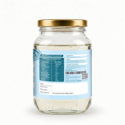 A glass jar of coconut oil with a gold metal lid, showing the back of the label with nutritional information, ingredients, and storage instructions on a white background.