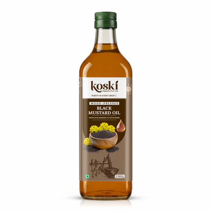 A bottle of Koski Wood-Fired Black Mustard Oil on a clean white background. The clear glass bottle shows the golden-brown oil inside, topped with a dark green cap and featuring a brown label with illustrations of mustard seeds and flowers.