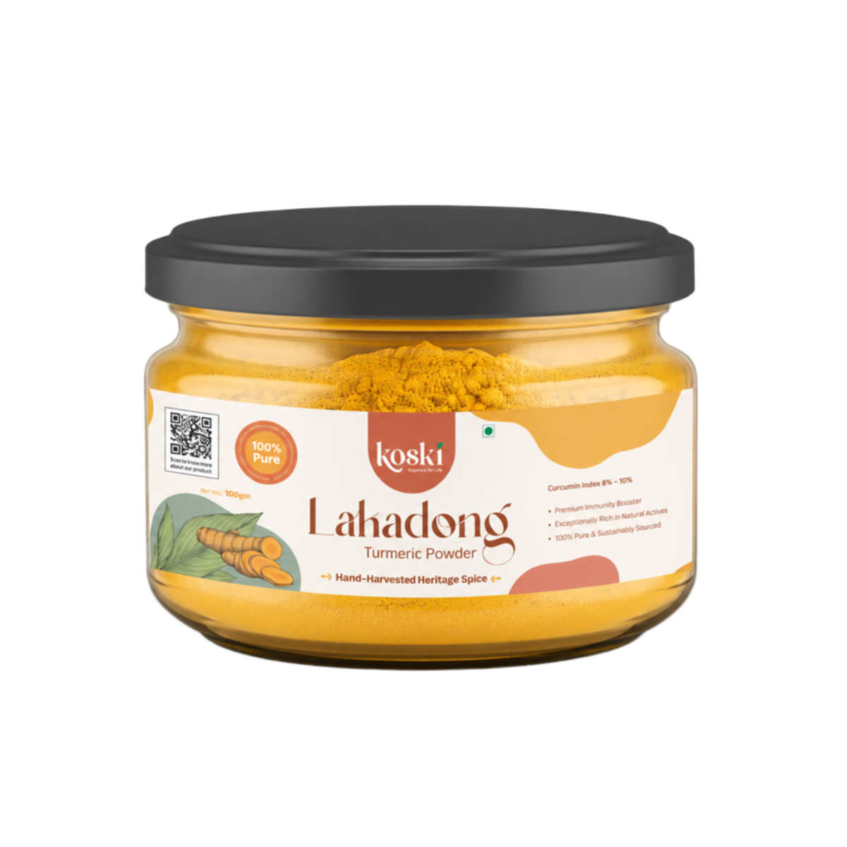 A jar of Koski Organics LaKadong Turmeric Powder on a plain white background. The product is in a clear glass jar showing the bright yellow turmeric powder inside, topped with a black lid