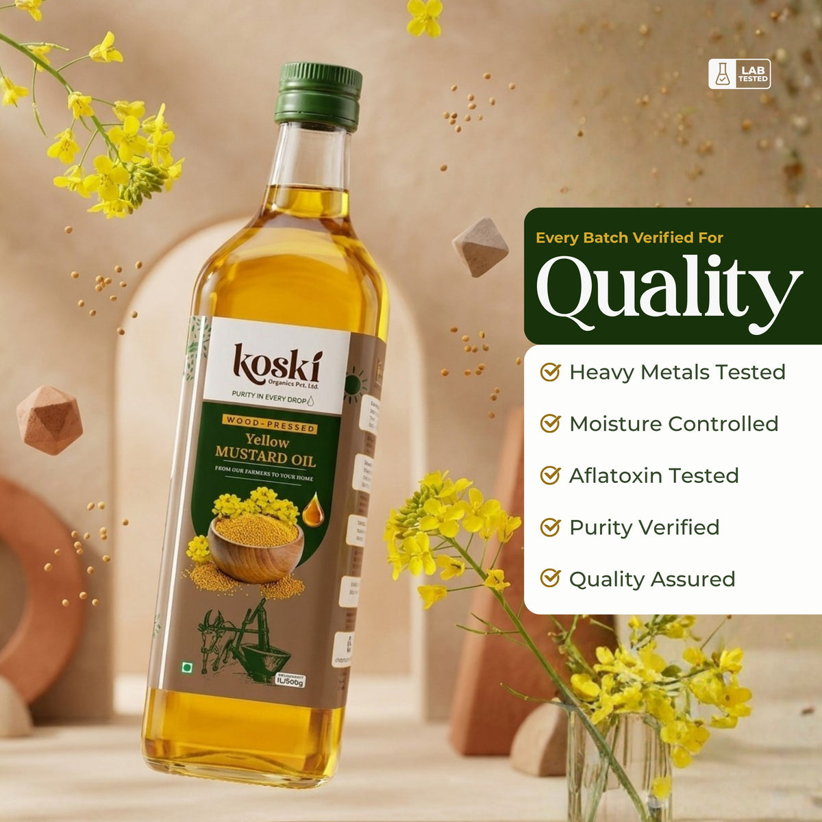 A bottle of Koski Yellow Mustard Oil floating in a warm, styled studio scene with yellow flowers and decorative elements. A green and white quality badge on the right lists verified attributes: heavy metals tested, moisture controlled, aflatoxin tested, purity verified, and quality assured.

Details