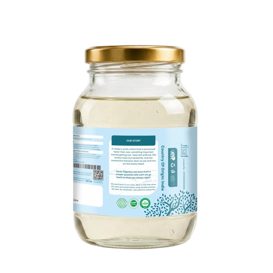 A clear glass jar of sea moss capsules with a gold metal lid and a light blue label, shown from the back on a white background.