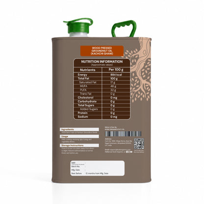 A 5 kg metal canister of wood pressed decocuminut oil (kachi gachi) shown from the back, featuring a brown body, green spout cap, and a detailed nutrition label.