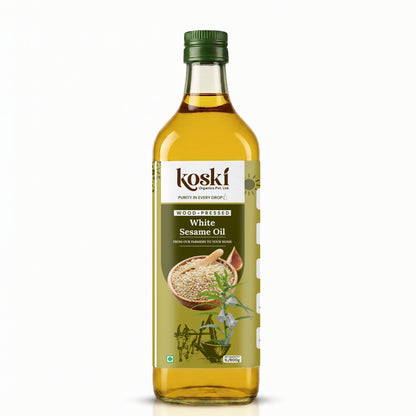 A 900ml bottle of Koski Organics Wood-Melting White Sesame Oil on a clean white background. The bottle is made of clear glass, showing the golden-yellow oil inside, and is topped with a dark green cap.