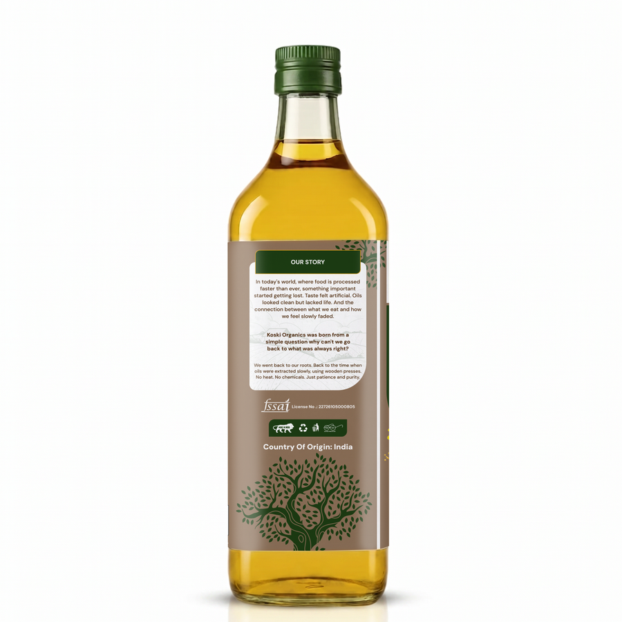A bottle of golden yellow olive oil with a green cap and a brown label featuring a tree illustration and text, shown on a clean white background.