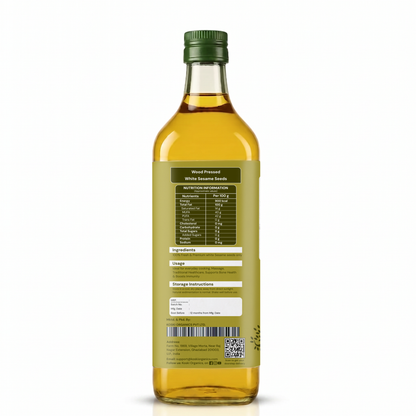 A bottle of white sesame seed oil shown from the back, featuring a dark green cap, golden-yellow oil inside, and a detailed product label with nutritional information, ingredients, and storage instructions.